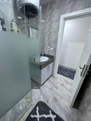 a bathroom with a sink and a shower at Luxurious Apartment in Selena Bay - Private Beach, 5 Pools and Kite Surfing in Hurghada