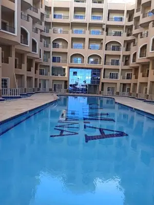 a large swimming pool in front of a building at Juliana Beach Resort Hurghada D402 in Hurghada