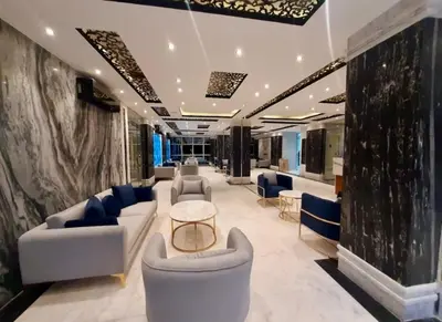 a lobby with couches and chairs in a building at Juliana Beach Resort Hurghada D402 in Hurghada