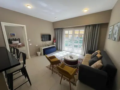 a living room with a couch and a table at Elegant 2BR Apartment • Ocean View Abu Tig Marina in Hurghada