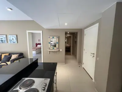a kitchen and living room with a couch and a table at Elegant 2BR Apartment • Ocean View Abu Tig Marina in Hurghada