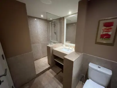 a bathroom with a sink and a toilet and a mirror at Elegant 2BR Apartment • Ocean View Abu Tig Marina in Hurghada