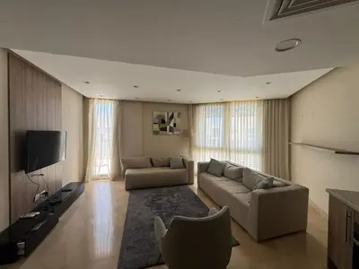 a living room with a couch and a tv at 3 Bdr Sea View with private roof Mangrovy EL Guna in Hurghada