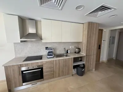 a kitchen with white cabinets and a sink at 3 Bdr Sea View with private roof Mangrovy EL Guna in Hurghada