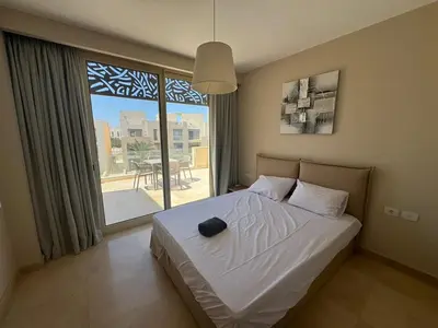 a bedroom with a bed and a large window at 3 Bdr Sea View with private roof Mangrovy EL Guna in Hurghada