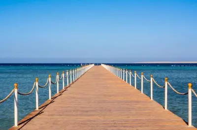 a wooden pier stretches out into the ocean at Scandic resort in Hurghada