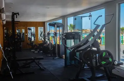 a gym with a row of treadmills and machines at Scandic resort in Hurghada