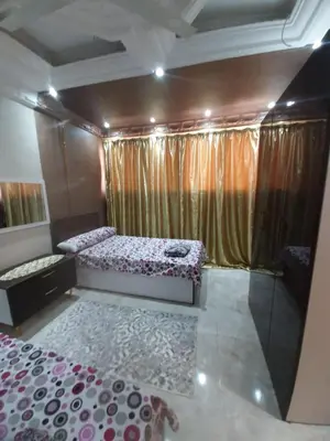 a bedroom with two beds in a room with curtains at Horus Heights in Idfu