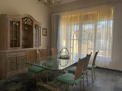 a dining room with a glass table and chairs at 4 Bedroom Seaside Hurghada Escape in Hurghada