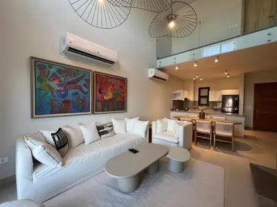 a living room with a white couch and a table at Bohemian-Style 3BR Townhouse in Shedwan, El Gouna. in Hurghada