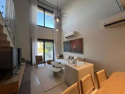 a living room with a couch and a tv at Bohemian-Style 3BR Townhouse in Shedwan, El Gouna. in Hurghada