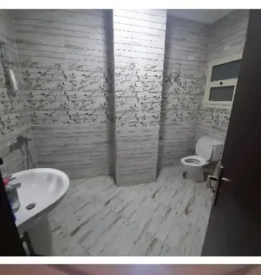 a bathroom with a white toilet and a sink at Casablanca Beach Appartment in Hurghada