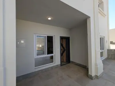 an empty room with two windows and a door at Magawish Studio 2 with Pool in Hurghada