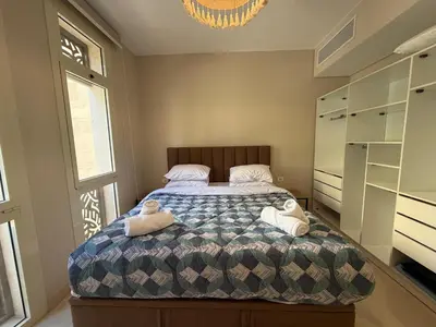 a bedroom with a bed with towels on it at Cozy 1BR GF Mangroovy Residence in Hurghada