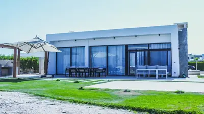 a house with a patio and an umbrella at Luxurious 5bdrooms villa Somabay in Hurghada