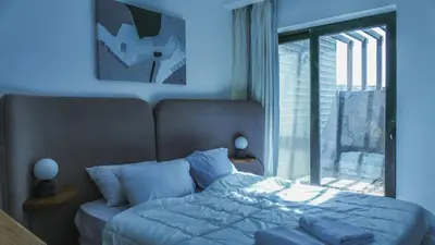 a bedroom with a bed with blue walls and a window at Luxurious 5bdrooms villa Somabay in Hurghada