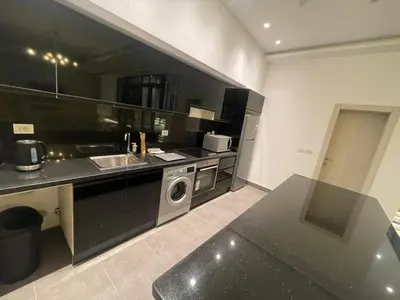 a kitchen with a sink and a washing machine at Luxurious 5bdrooms villa Somabay in Hurghada