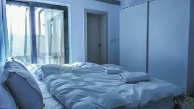 an unmade bed in a room with a window at Luxurious 5bdrooms villa Somabay in Hurghada