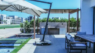 a patio with a table and an umbrella at Luxurious 5bdrooms villa Somabay in Hurghada