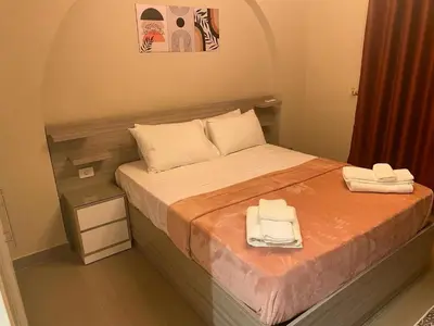 a small bedroom with a bed with two towels on it at Exclusive Villa in Sabina • 4 BR • Private Pool in Hurghada