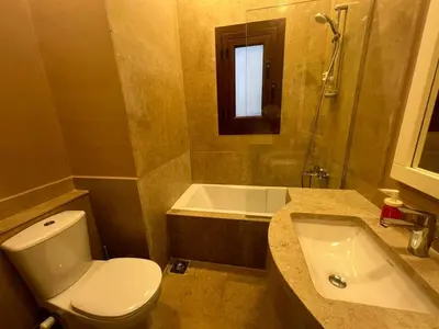 a bathroom with a toilet and a sink and a tub at Exclusive Villa in Sabina • 4 BR • Private Pool in Hurghada