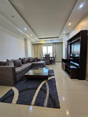 a living room with a couch and a television at touristic center in Hurghada