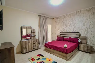 a bedroom with a pink bed and a mirror at touristic center in Hurghada