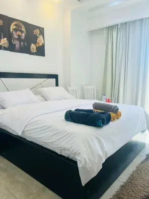 a bedroom with a bed with two pillows on it at touristic center in Hurghada