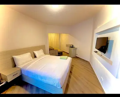 a bedroom with a bed and a flat screen tv at Luxury flat in Hurghada