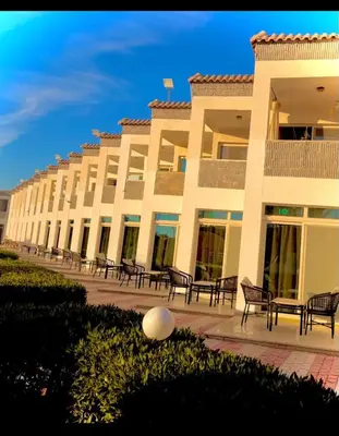 a large building with benches in front of it at Luxury flat in Hurghada