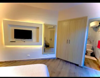 a bedroom with a large mirror and a tv on the wall at Luxury flat in Hurghada