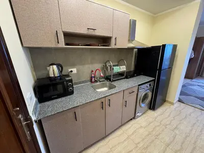 a kitchen with a sink and a microwave at Studio in Hurghada