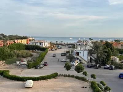 an aerial view of a parking lot next to the ocean at Studio in Hurghada