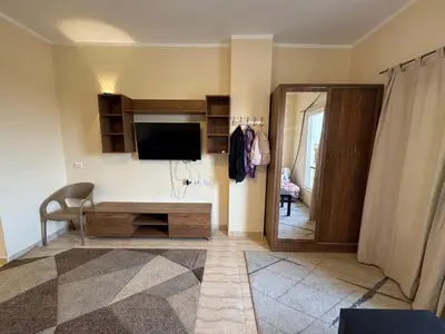a living room with a television and a table at Studio in Hurghada