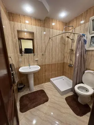 a bathroom with a sink and a toilet and a shower at Hurghada 201 in Hurghada