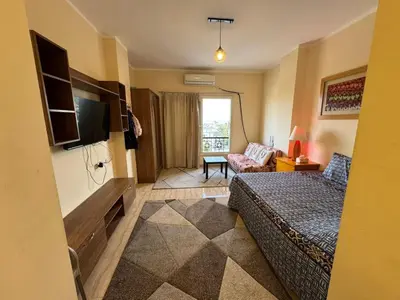 a hotel room with a bed and a television at Hurghada 201 in Hurghada