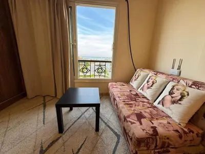 a living room with a couch and a table and a window at Hurghada 201 in Hurghada