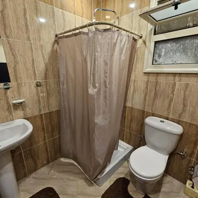 a bathroom with a toilet and a shower curtain at Hurghada 201 in Hurghada
