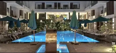 a large swimming pool with umbrellas in a building at 422batthepavillionImperialHurghada in Hurghada