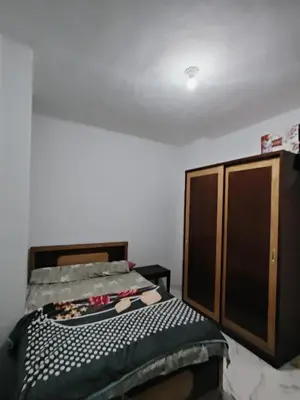 a bedroom with a bed and a cabinet at Turtles Beach Chalet in Hurghada