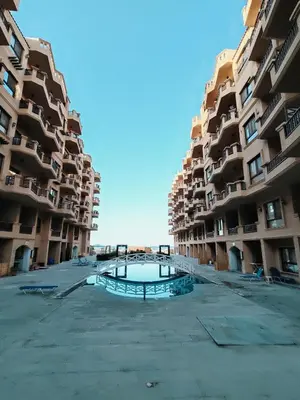 an empty parking lot in front of some apartment buildings at Turtles Beach Chalet in Hurghada