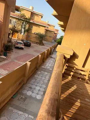 a balcony with a wooden railing and a parking lot at Modern 1BR Seaside Apartment C1 in Turtles Beach in Hurghada