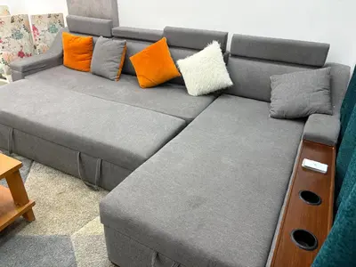 a gray couch with pillows on it in a living room at Modern 1BR Seaside Apartment C1 in Turtles Beach in Hurghada