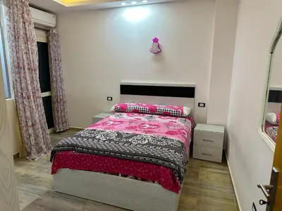 a bedroom with a bed with a pink blanket at صف اول على البحر مباشر منطقة القيادات شقة رقم 3 in Hurghada