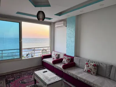 a living room with a couch and a view of the ocean at صف اول على البحر مباشر منطقة القيادات شقة رقم 3 in Hurghada