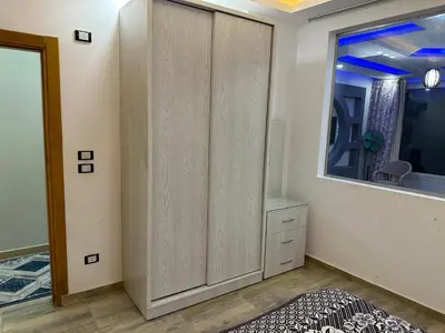 a bedroom with a large wardrobe and a window at صف اول على البحر مباشر منطقة القيادات شقة رقم 3 in Hurghada