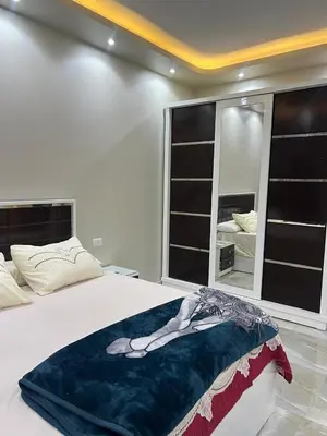 a bedroom with a woman laying on a bed at القيادات صف ثاني in Hurghada