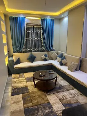 a living room with a couch and a table at القيادات صف ثاني in Hurghada