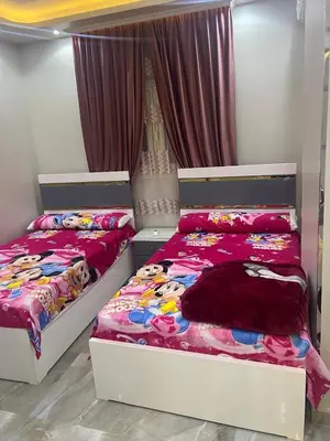 two beds sitting next to each other in a bedroom at القيادات صف ثاني in Hurghada