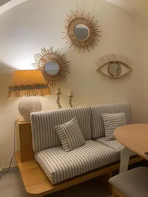 a living room with a couch and two mirrors at West Golf beautiful Townhouse in Hurghada
